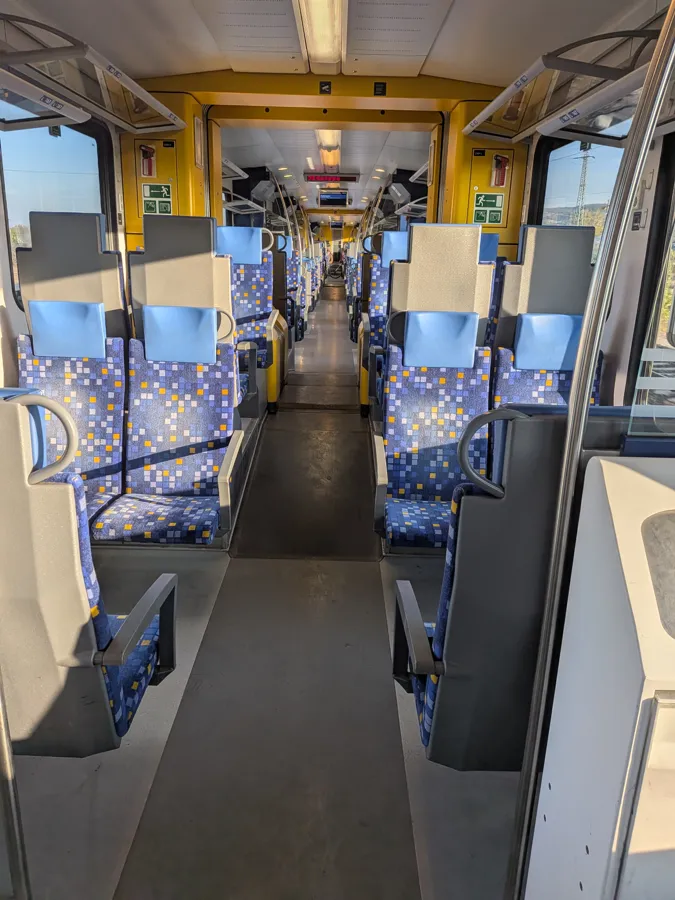 Inside the train to Esztergom: blue seats, sunshine and plenty of room